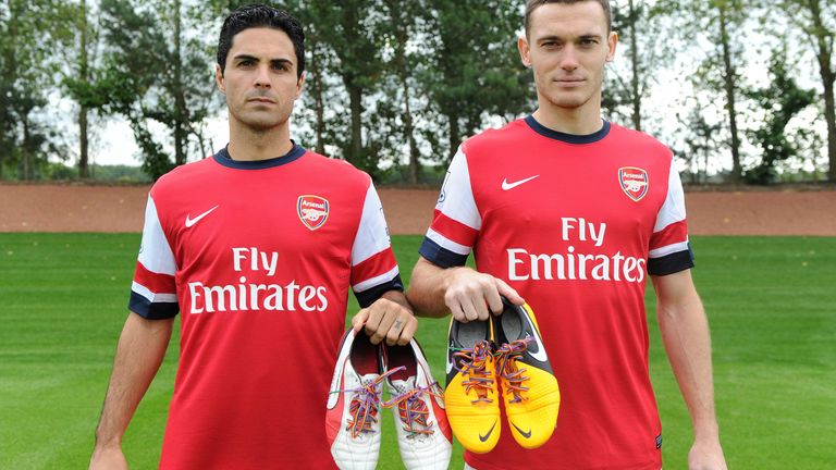 LONDON, ENGLAND - SEPTEMBER 22: Mikel Arteta and Thomas Vermaelen of Arsenal pose with their rainbow laces during the Arsenal 1st team squad photoshoot at Arsenal Training Ground on September 20, 2013 in London, England. Photo by David Price/Arsenal FC via Getty Images)