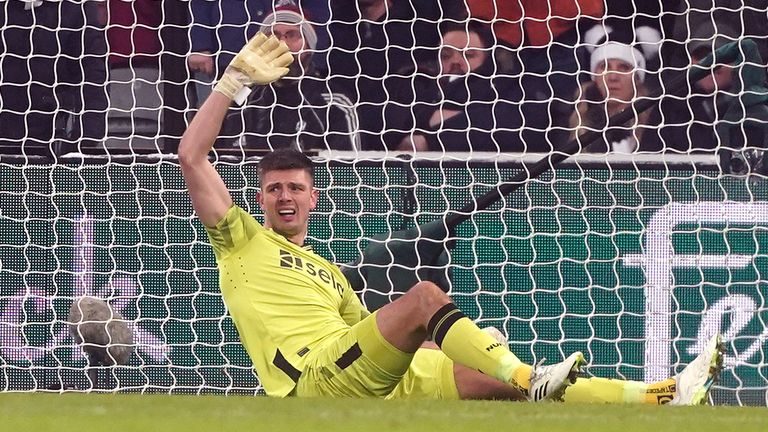 Nick Pope signals to the bench after picking up an injury